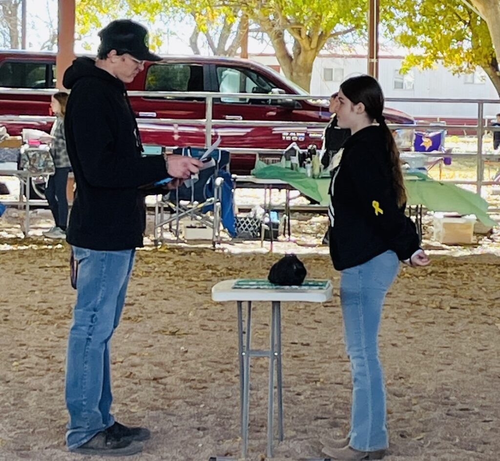 Girl presenting rabbit to judge.